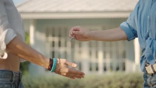 Real-estate Agent Giving Keys To New Property Owners. Summer Time
