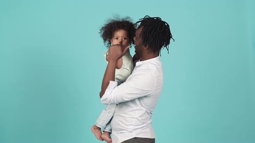 Loving Father Holds Child in Studio