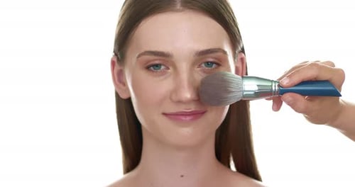 Woman Receiving Makeup Application with Brush