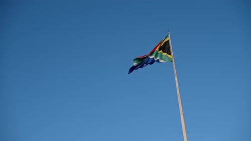 South African Flag Flying Against Blue Sky