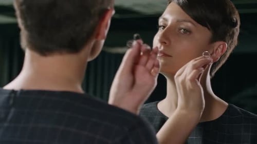 Young Woman Puts in Decorative Heart Earring