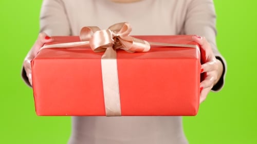 Woman Presents a Wrapped Gift on Green Screen