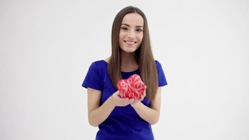 Smiling Woman Holds Heart Shaped Gift