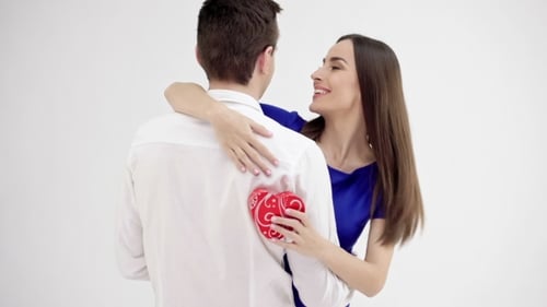 Woman Gives Heart Gift to Man During Embrace
