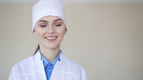 Smiling Young Woman Doctor in White Lab Coat