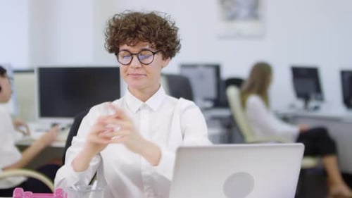 Woman Exercising with Dumbbells at Office Desk