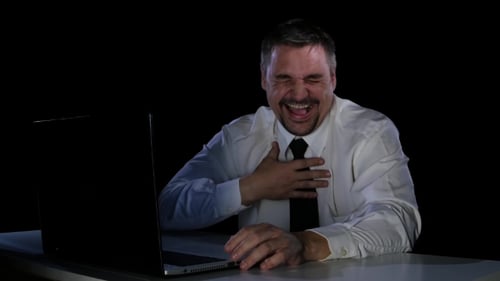 Young Man Laughing at a Funny Video From the Internet