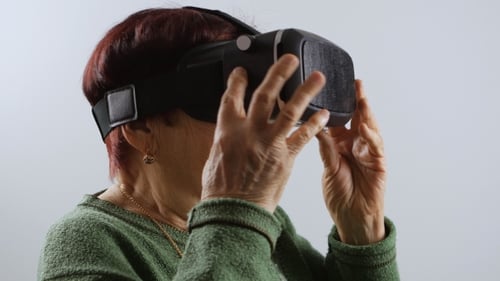 Senior Woman Experiences Virtual Reality Headset Technology