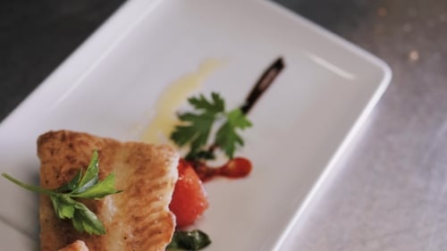 Plated Fish Dish with Tomatoes and Parsley