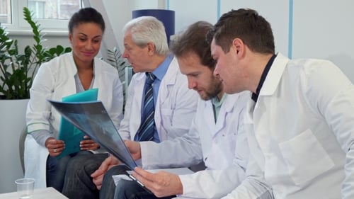 Medical Team Reviewing X-Ray in Office Setting