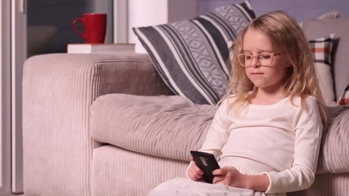 Girl Using Smartphone Sitting at Home
