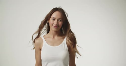 Beautiful Woman Poses in White Tank Top