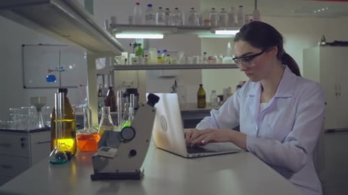 Female Scientist Working on Laptop in Lab