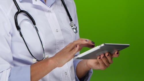Female Hands Doctors Work on the Tablet Pc.