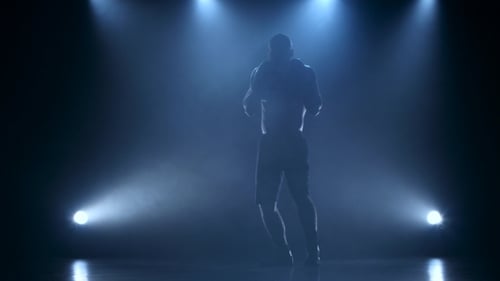 Strong and Muscular Body of a Boxer in Silhouette