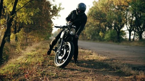 Unrecognizable Man in Helmet and Leather Jacket Coming Up to His Bike and Starting the Engine While