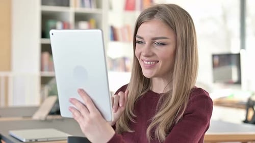 Smiling Woman Video Conferencing on Tablet at Home