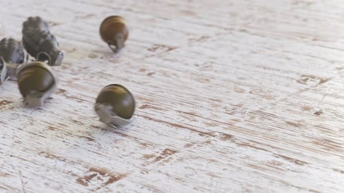 Realistic Hand Grenades Falling and Rolling on Wooden Surface
