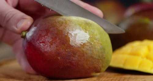 Slicing a Fresh Mango on a Wooden Board