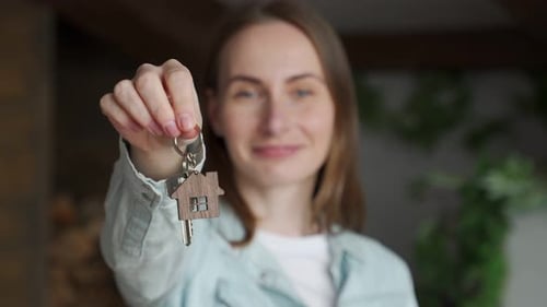 Woman Holds House Keys with Keychain