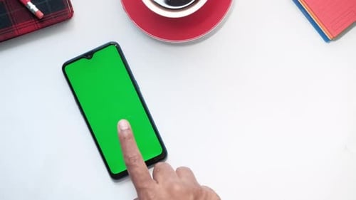 Top View of Hand Using Smart Phone on White Background