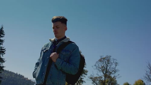 Man Standing Still Outdoors in Denim Jacket