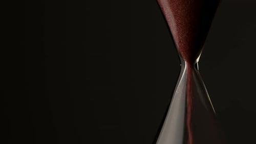 Elegant Hourglass with Red Sand Falling