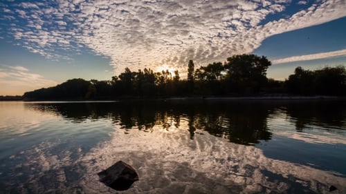 Movement of Clouds Over a Lake at Dawn