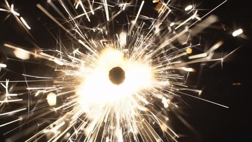 Golden Sparkler Lights Against Black Background