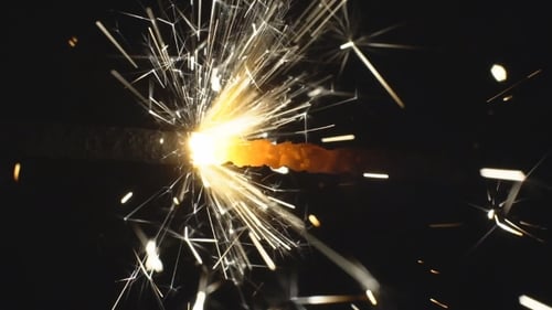 Sparkler Emitting White Sparks on Black Background