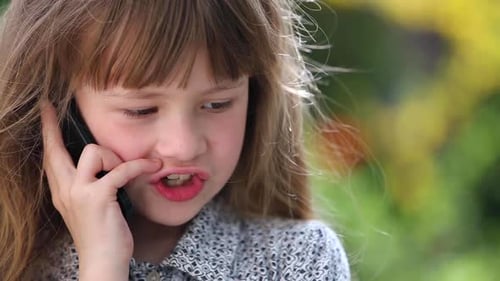 Portrait of Pretty Little Child Girl Talking on Mobile Phone