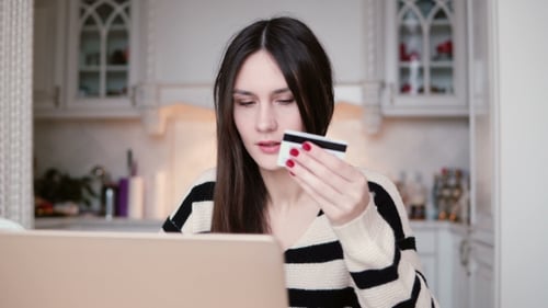 Young Woman Shopping Online with Credit Card and Laptop