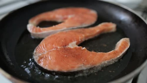 Salmon Steaks Frying in Pan at Home