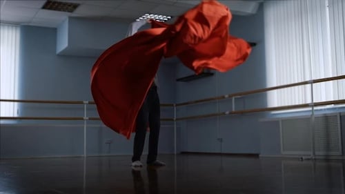 Dancer Performs His Emotional Dance Using a Large Red Cloth in a Large Studio. Attributes for Modern