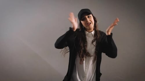 The Girl in the Gray Wall in the Studio. It Fulfills Movement. She Is Very Self-assured. Dancing Is