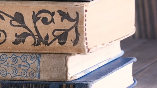 Stack of Decorative Hardcover Books on Table