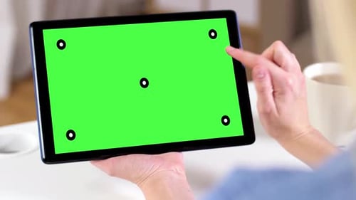Hands Holding Tablet Pc with Green Screen at Home