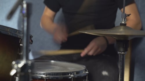 Drummer Playing a Snare and Cymbal in Studio