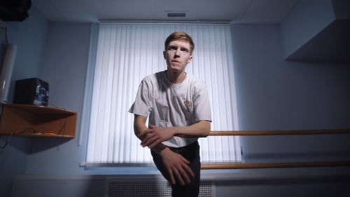 Man Dancing in a Room with Blue Walls