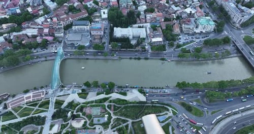 Aerial view of Tbilisi city central park and Bridge of Peace. Beautiful cityscape of old Tbilisi at