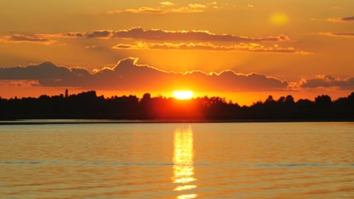 Colour Sunset Over The River With Sun And Orange Clouds