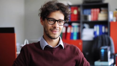 Smiling Young Man in Eyeglasses at Office