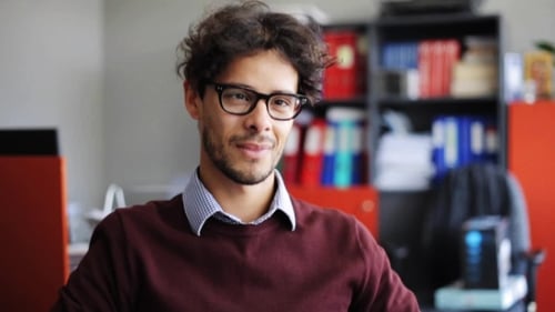Smiling Young Man in Eyeglasses at Office