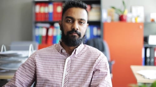 Happy Smiling Man with Beard at Office