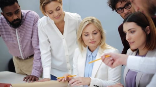 Business Team with House Blueprint at Office