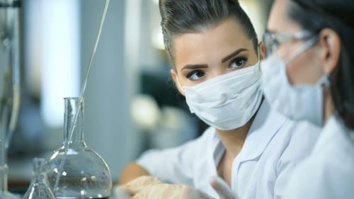 Scientists in a Laboratory Working on Chemical Testing and Discussing and Analysing Results