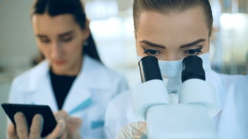 Women Working With Microscope in Modern Laboratory