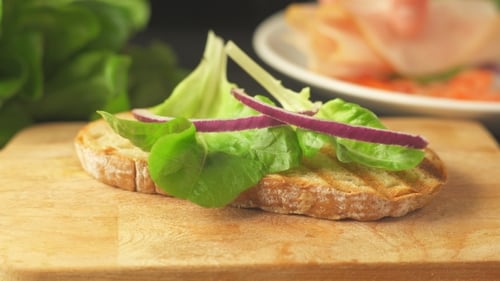 Sandwich Preparation with Fresh Ingredients on Bread