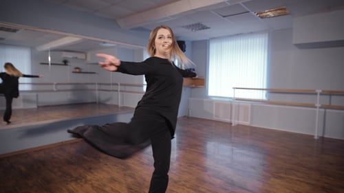 Hall for Dancing. A Woman in a Good Mood. She Rehearses Dance. Dance Is a Hobby for Her. She Tries