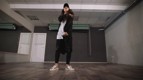 Stylish Woman Dancing Freely in Dance Studio